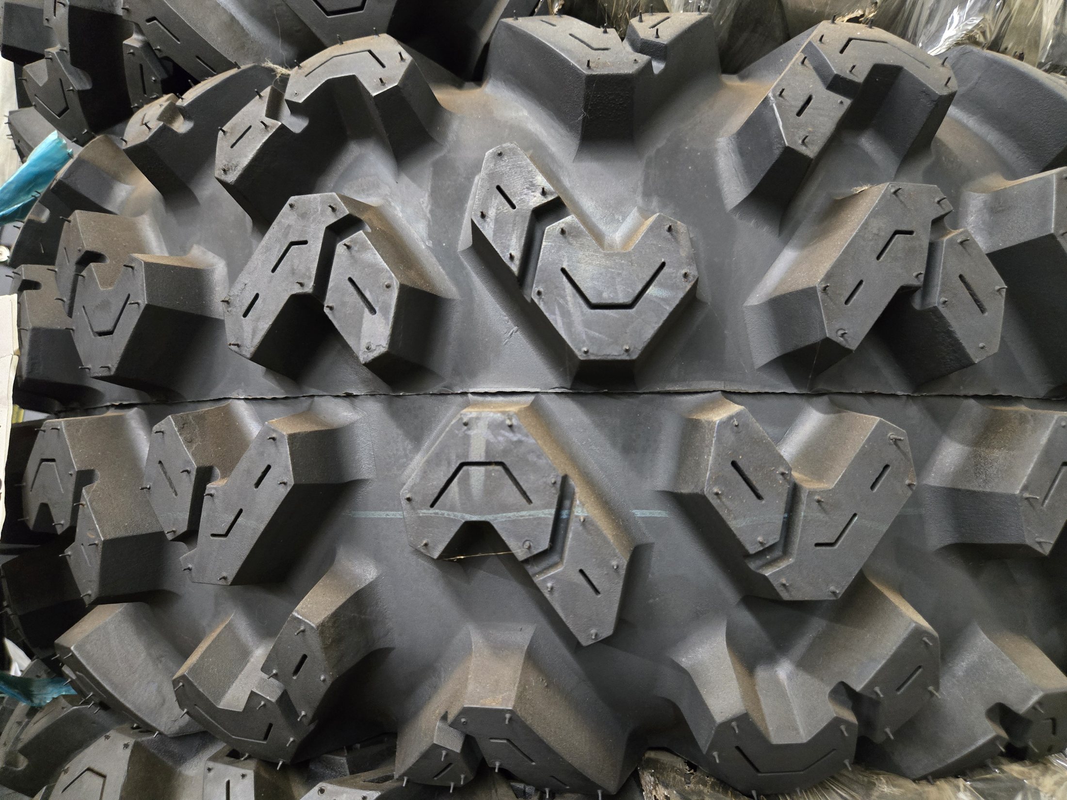 Close-up of a chunky ATV / UTV tire tread in stock at Rickie's Shop