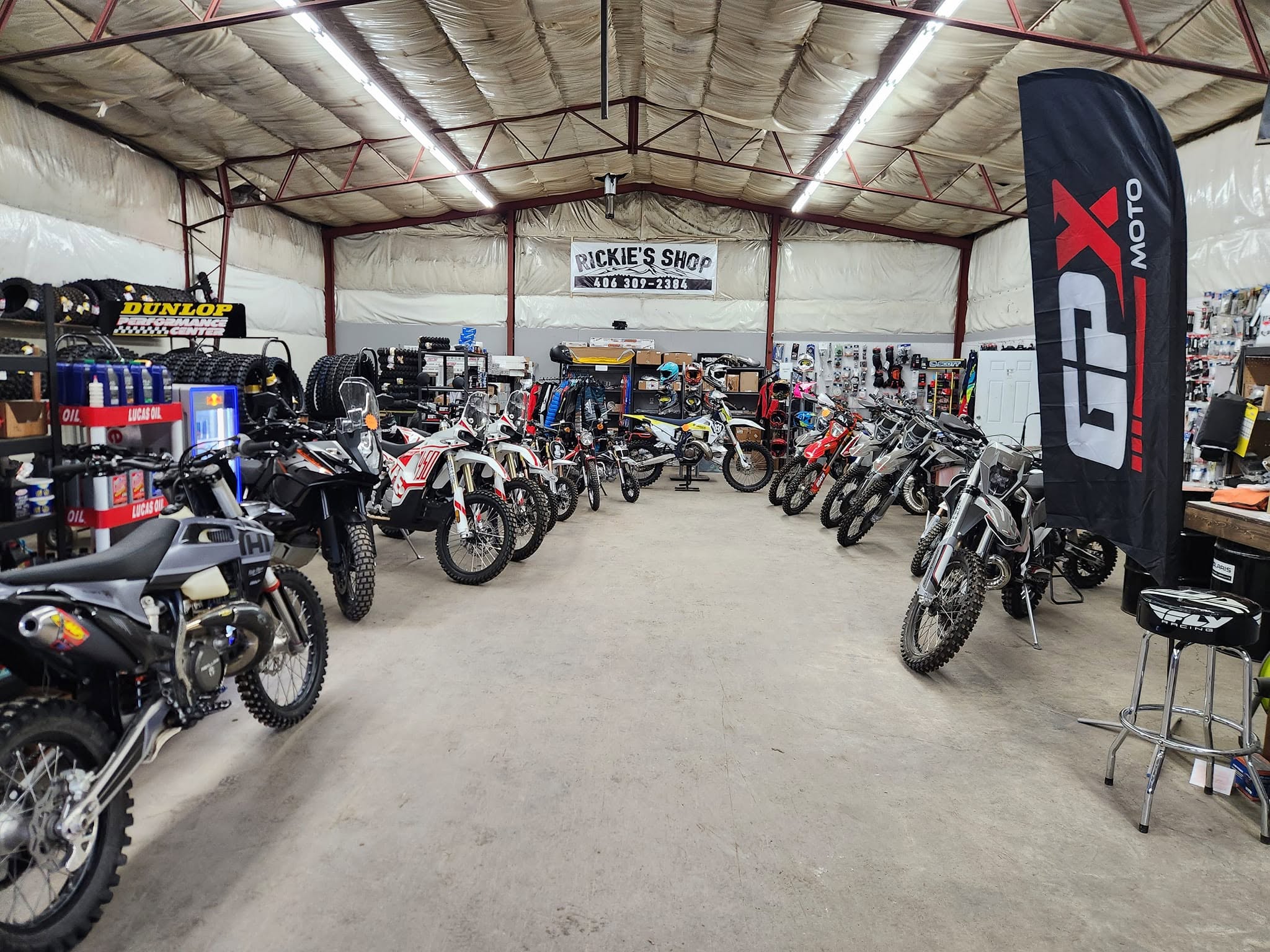 Wide interior view of Rickie's Shop showing rows of motorcycles down the center aisle