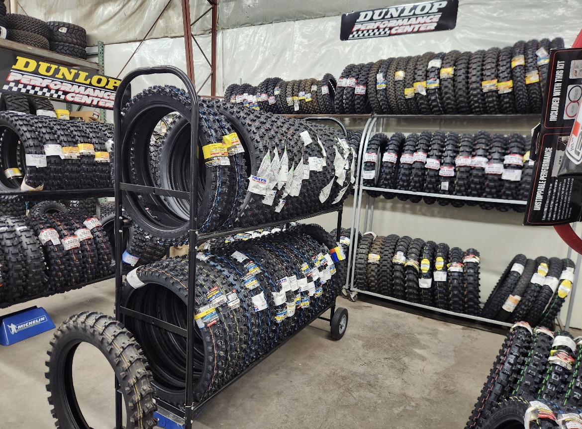 Dunlop Performance Center tire display at Rickie's Shop, stocked with motorcycle, ATV, and dirt bike tires